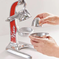 Manual citrus juicer with red and silver metal frame, lever arm, and two metal juicing cones of different sizes.