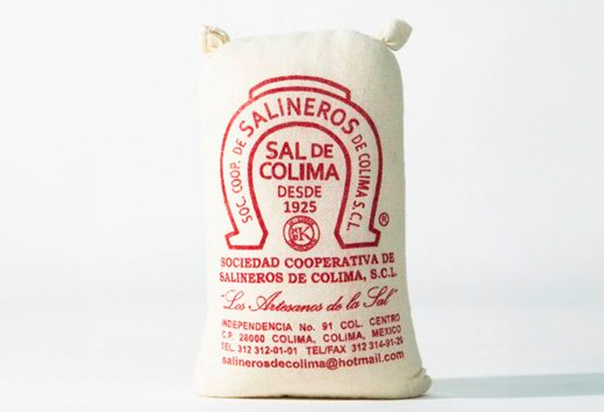 Cream-colored cloth bag with red horseshoe logo and Spanish text for Sal de Colima sea salt, featuring drawstring closure.